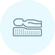 Icon of a person laying down on a mattress on a light blue circle