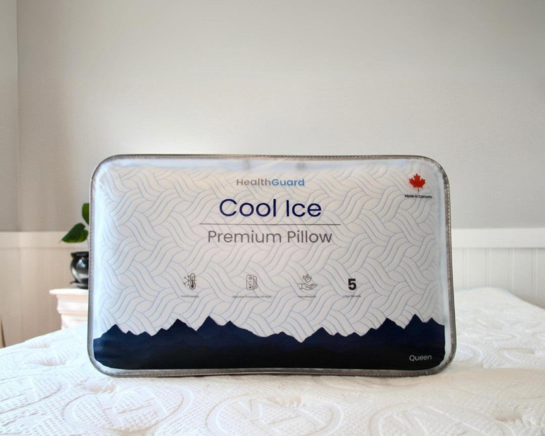 Haven Cool Ice Premium Pillow in its original packaging, featuring a cooling wave pattern design, HealthGuard branding, and a Canadian maple leaf emblem, displayed on a bed with a quilted mattress.