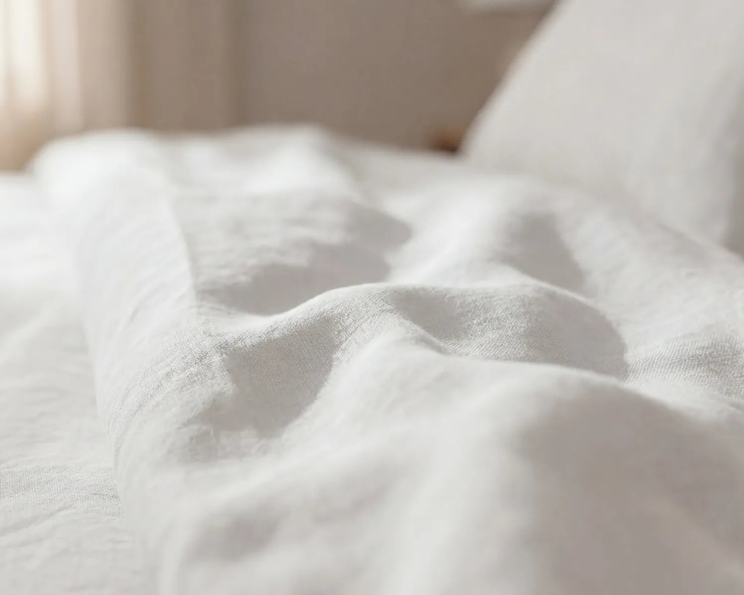 Close-up of soft white fabric with a blurred background