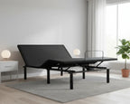 Black adjustable bed in a room with a window, plant, and nightstand.