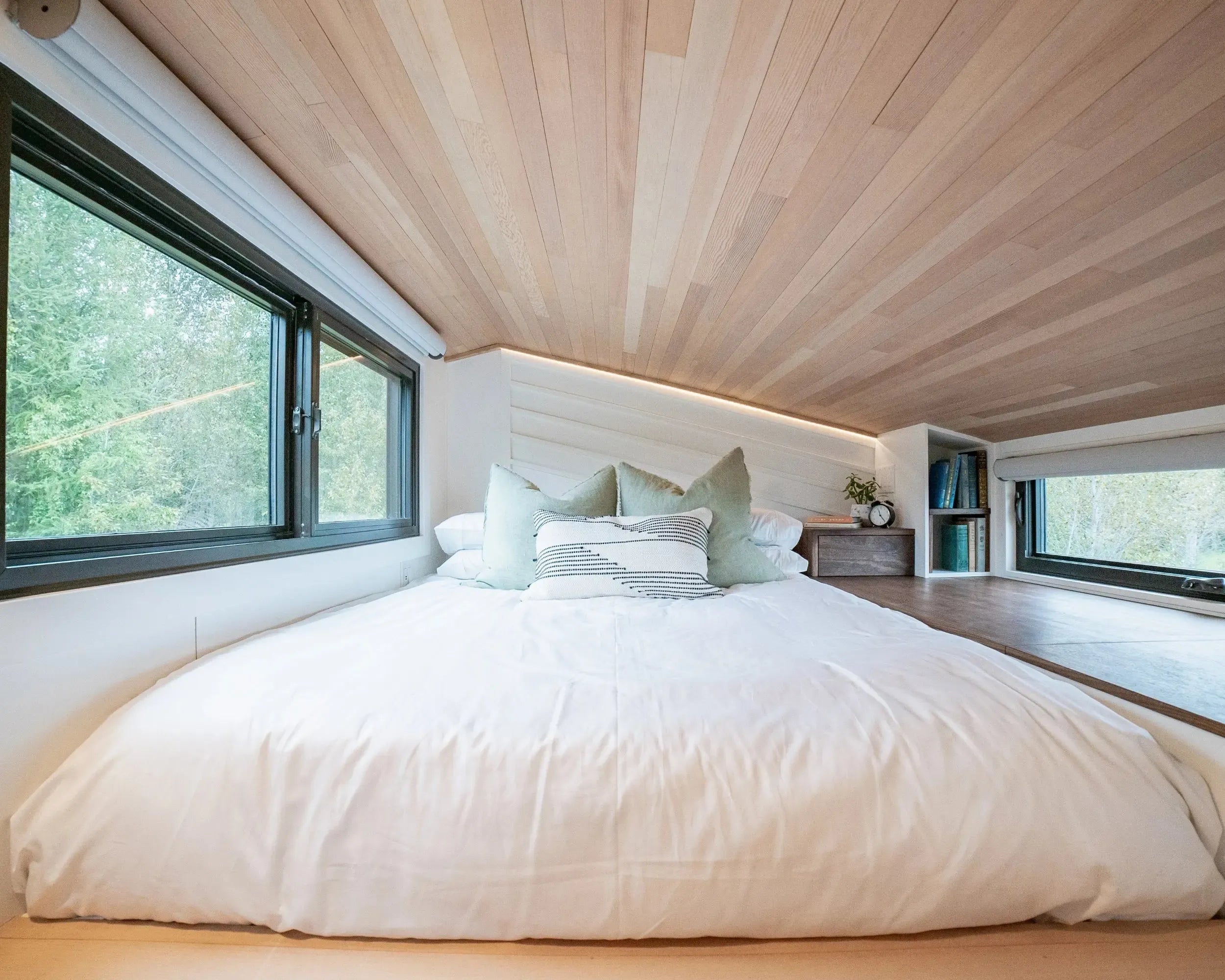 Modern bedroom with wooden ceiling and large windows
