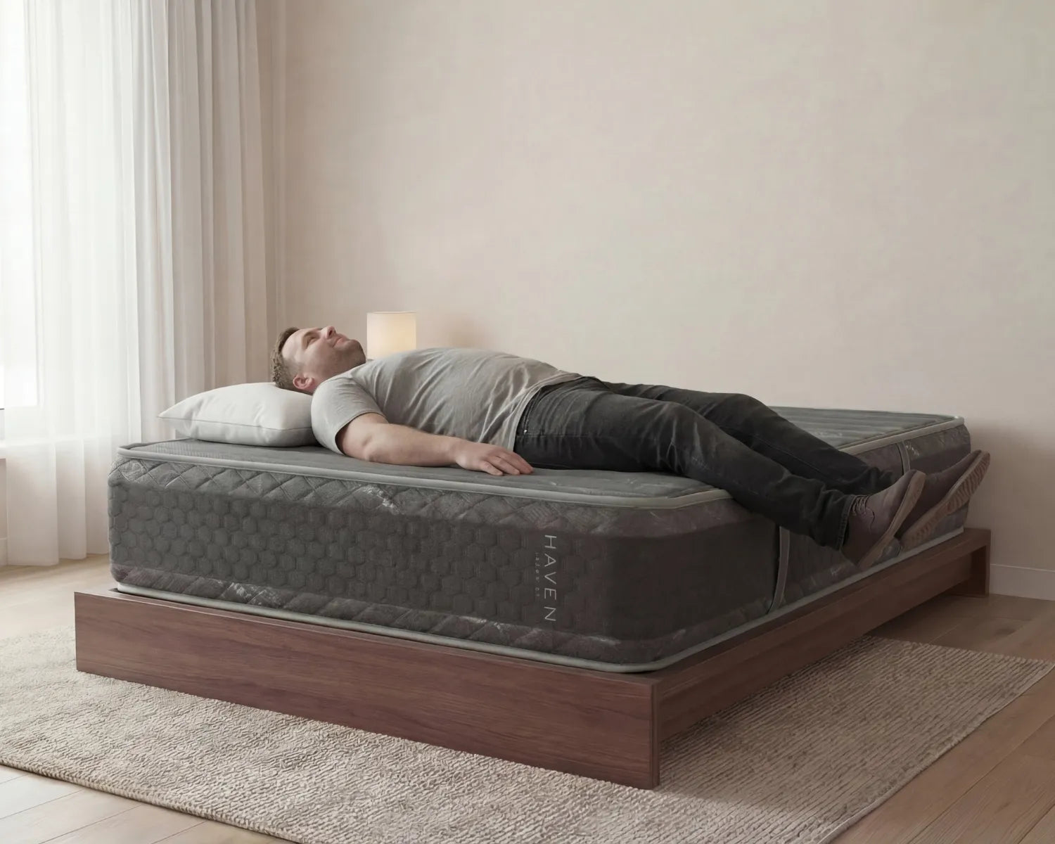 Man lying on a Haven mattress in a bedroom setting