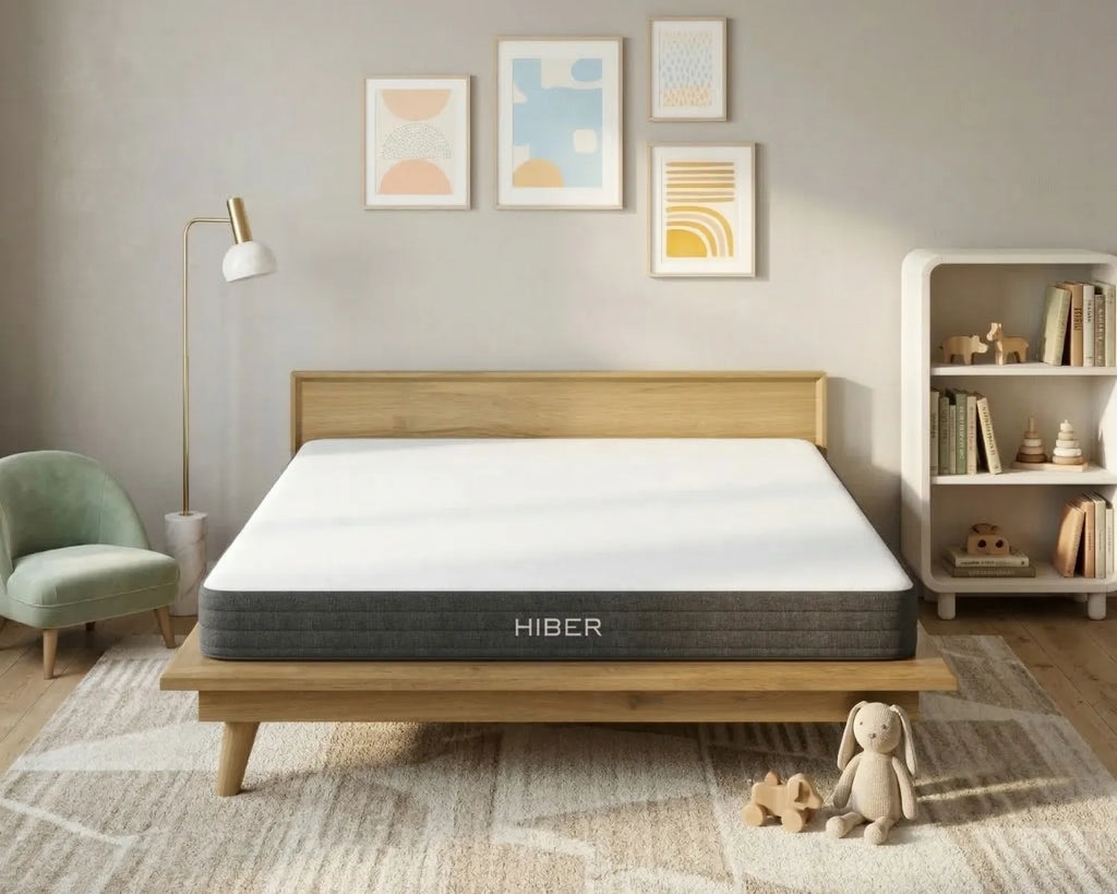 Hiber mattress on a wooden bed frame in a bedroom setting with decor elements.