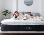 Woman relaxing with a book on a Haven LUX Pillowtop Hybrid Mattress, Canadian-made luxury bed with plush top in cozy, modern bedroom