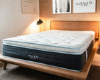 Mattress with 'HAVEN' branding on a wooden bed frame in a bedroom setting.