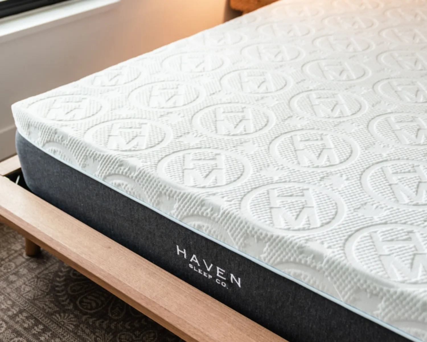 Mattress with Haven Sleep Co. branding on a wooden bed frame.