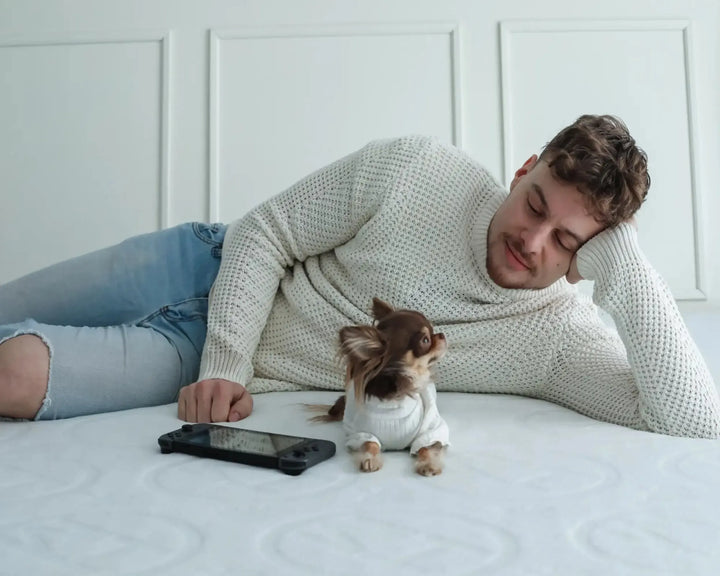 Man and dog laying on Haven mattress 