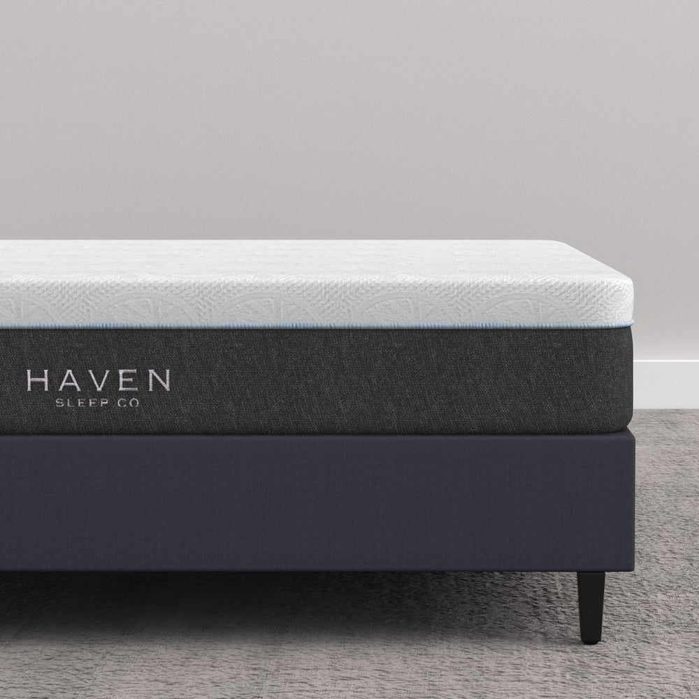 LUX Rejuvenate Mattress by Haven Sleep Co. - Canadian-made mattress offering cradling comfort with firm support, shown on a dark platform bed frame in a modern, minimalist bedroom.