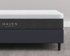 LUX Rejuvenate Mattress by Haven Sleep Co. - Canadian-made mattress offering cradling comfort with firm support, shown on a dark platform bed frame in a modern, minimalist bedroom.