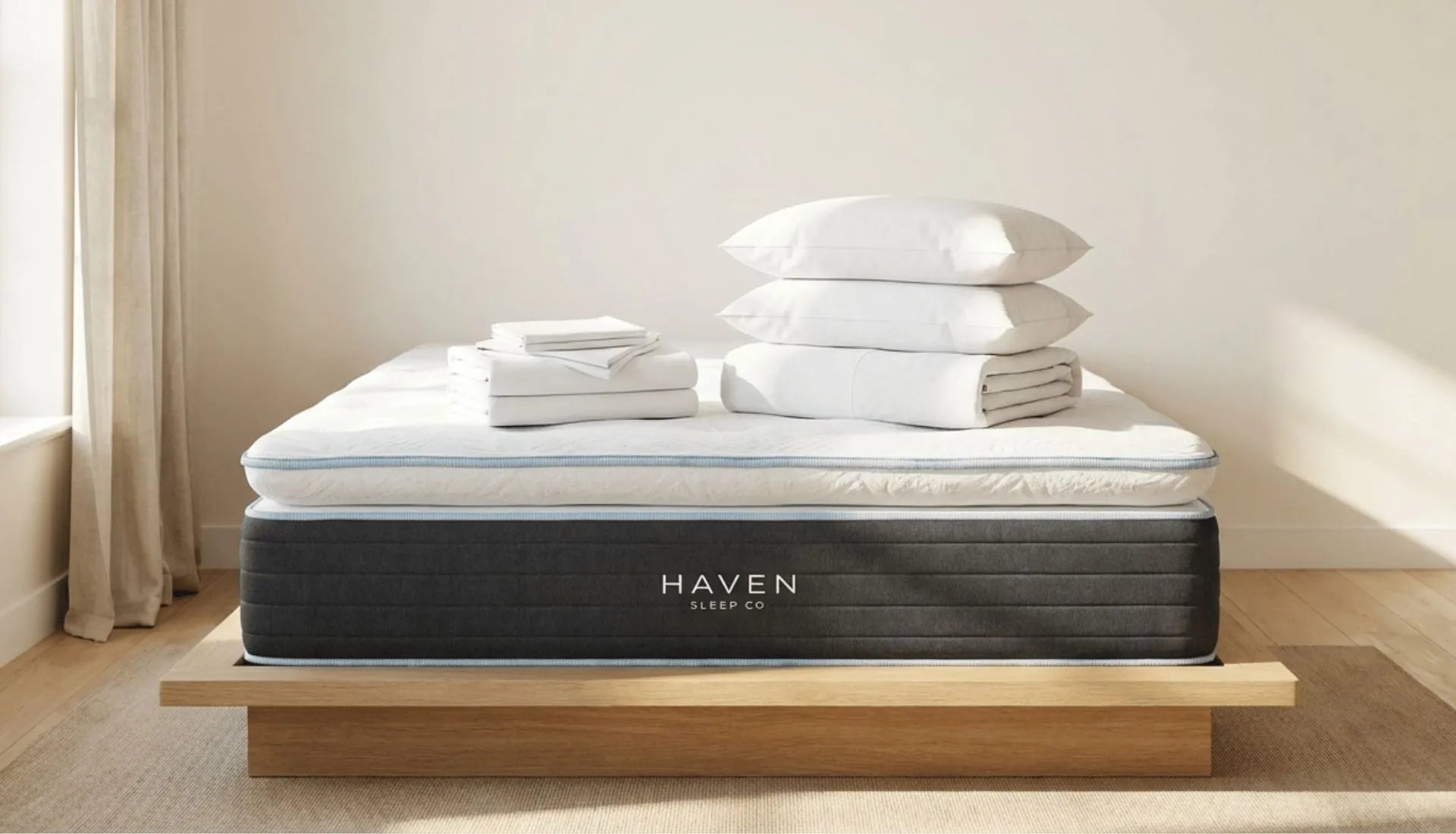 Haven mattress in room with bedding folded on top of mattress 
