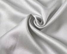 Close-up of smooth white satin fabric from the Dream Satin Sleep Set, showcasing its glossy and luxurious texture, a sustainable and cruelty-free alternative to traditional silk, designed for a comfortable and rejuvenating sleep experience.