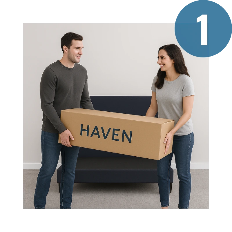 Two people holding a cardboard box labeled 'HAVEN' in a room.