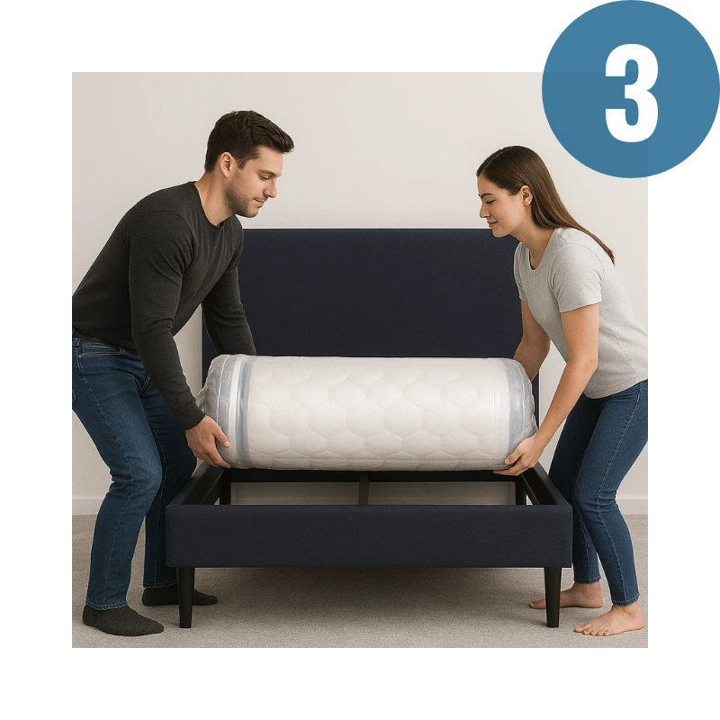 Two people unrolling a mattress on a bed frame.