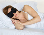 woman in white with a pair of Bedface blackout 40 blinks sleep mask sleeping on top of a memory foam pillow and Haven mattress with Starlight White sheet set