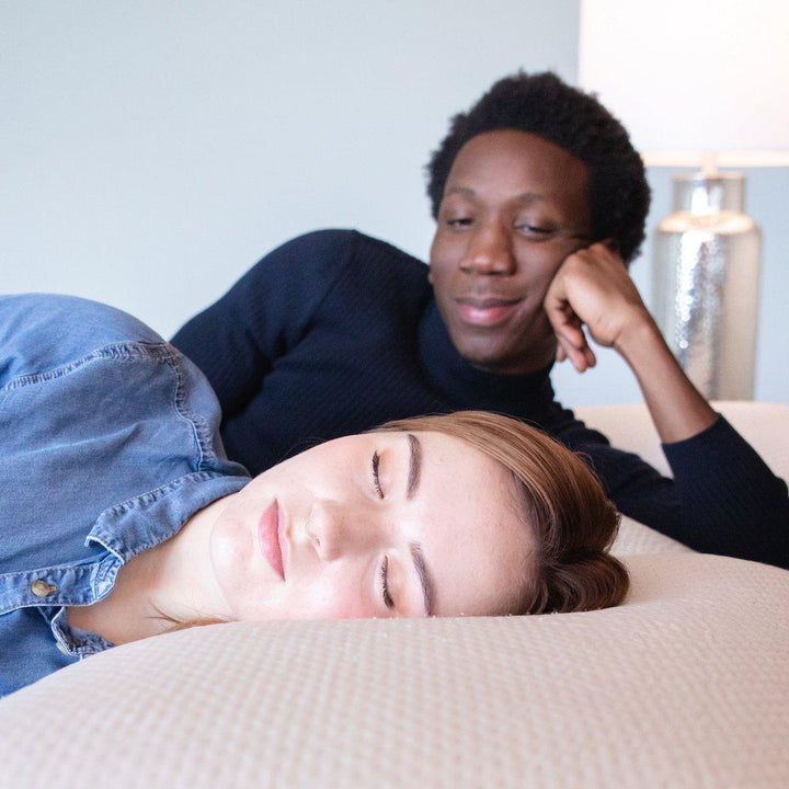 man staring lovingly at woman as she sleeps on a Bedface icegel pillow on a Haven Mattress