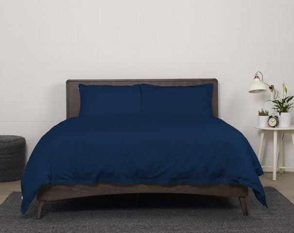 showcase of Bedface 100% Cotton Percale European bundle collection with Sheet set and Duvet cover in Nighttime Navy on a Haven mattress Bed-in-box on a dark brown bed frame 