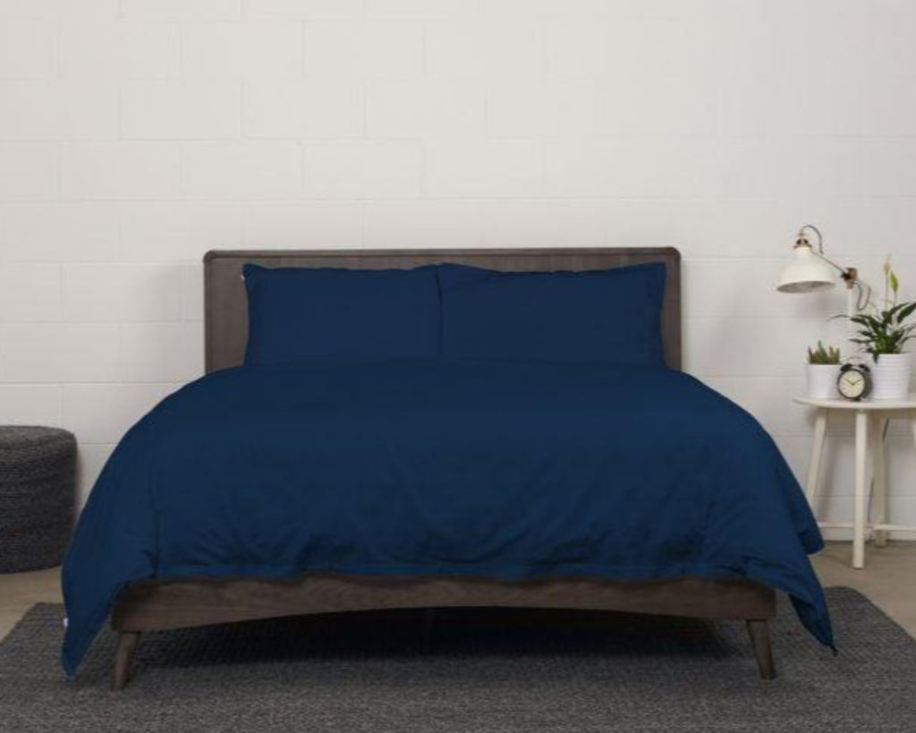 showcase of Bedface 100% Cotton Percale European bundle collection with Sheet set and Duvet cover in Nighttime Navy on a Haven mattress Bed-in-box on a dark brown bed frame 